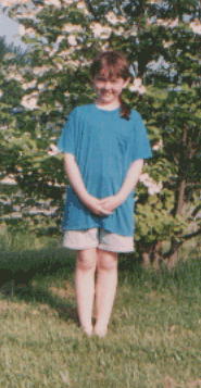Sarah in front of a flowering tree